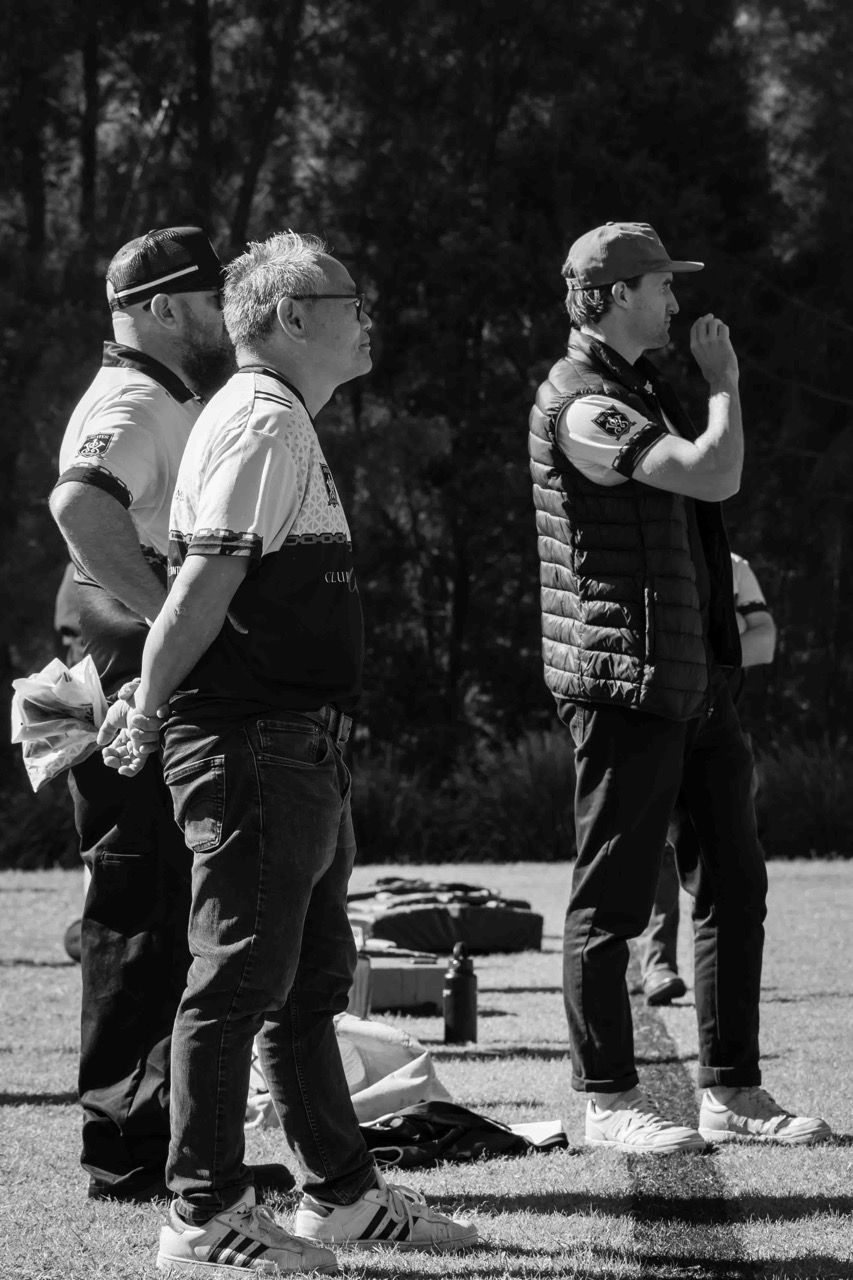 Coaches watch the game from the sideline