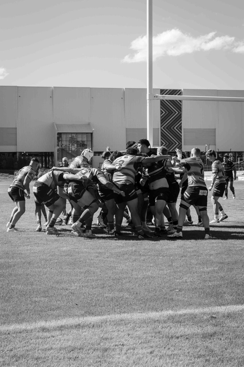 Forwards pack down in a scrum in the sun