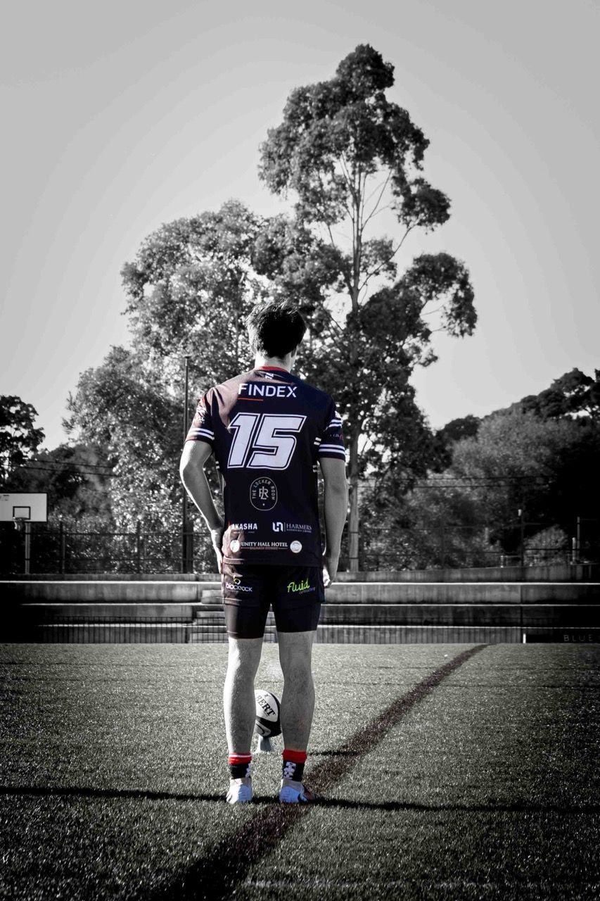 A player in number 15 looks downfield, seen from behind