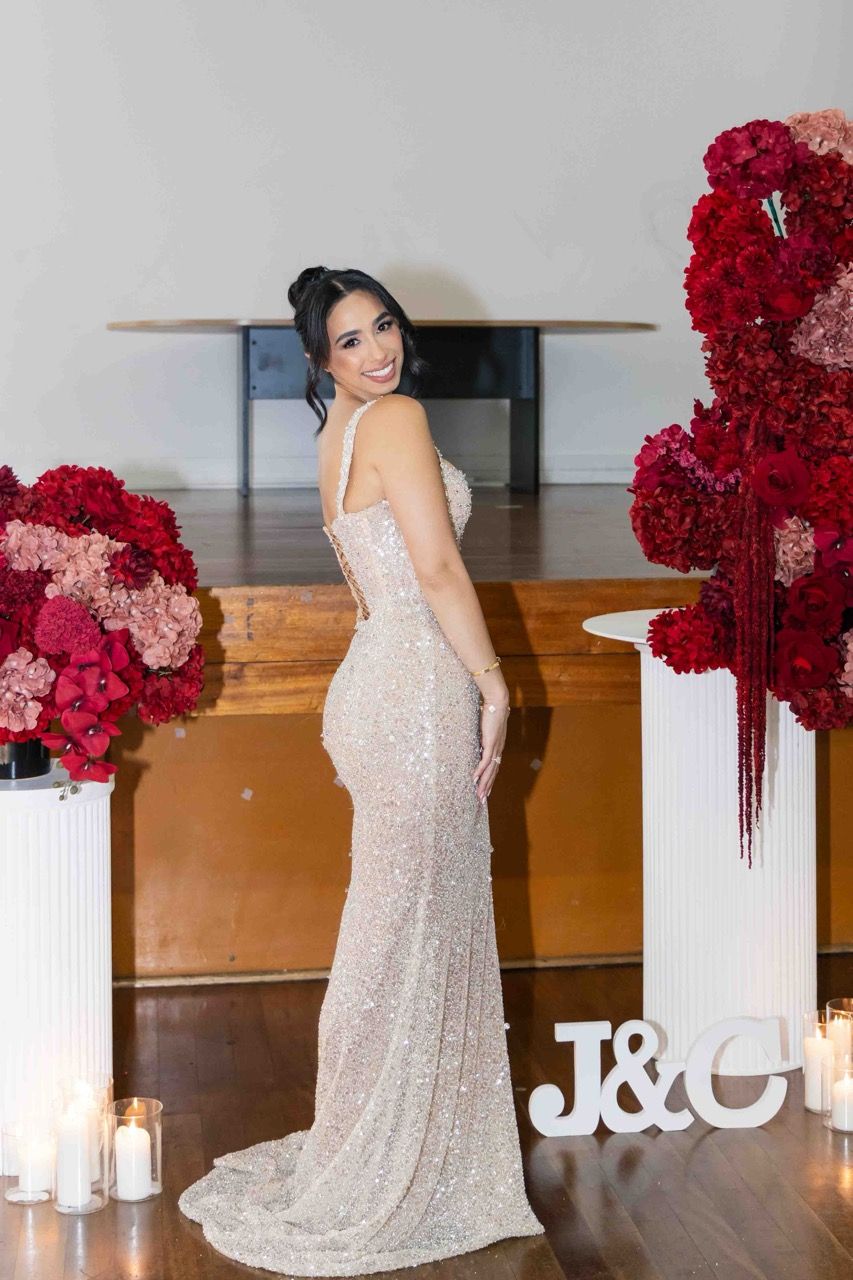 The bride-to-be looks back over her shoulder by candlelight