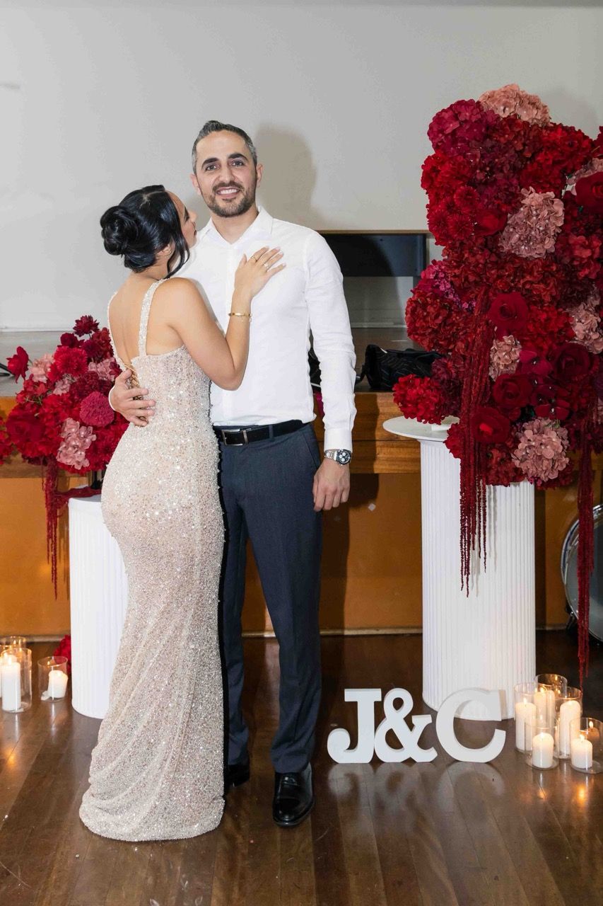 The couple embrace in front of their initials